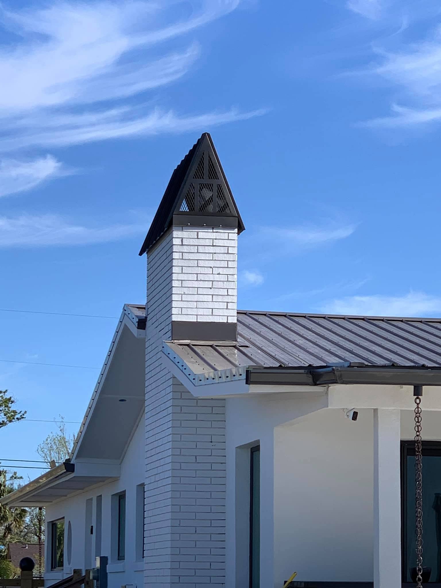 Custom chimney cap designed to match the home's roofline and pitch for a seamless, finished appearance.