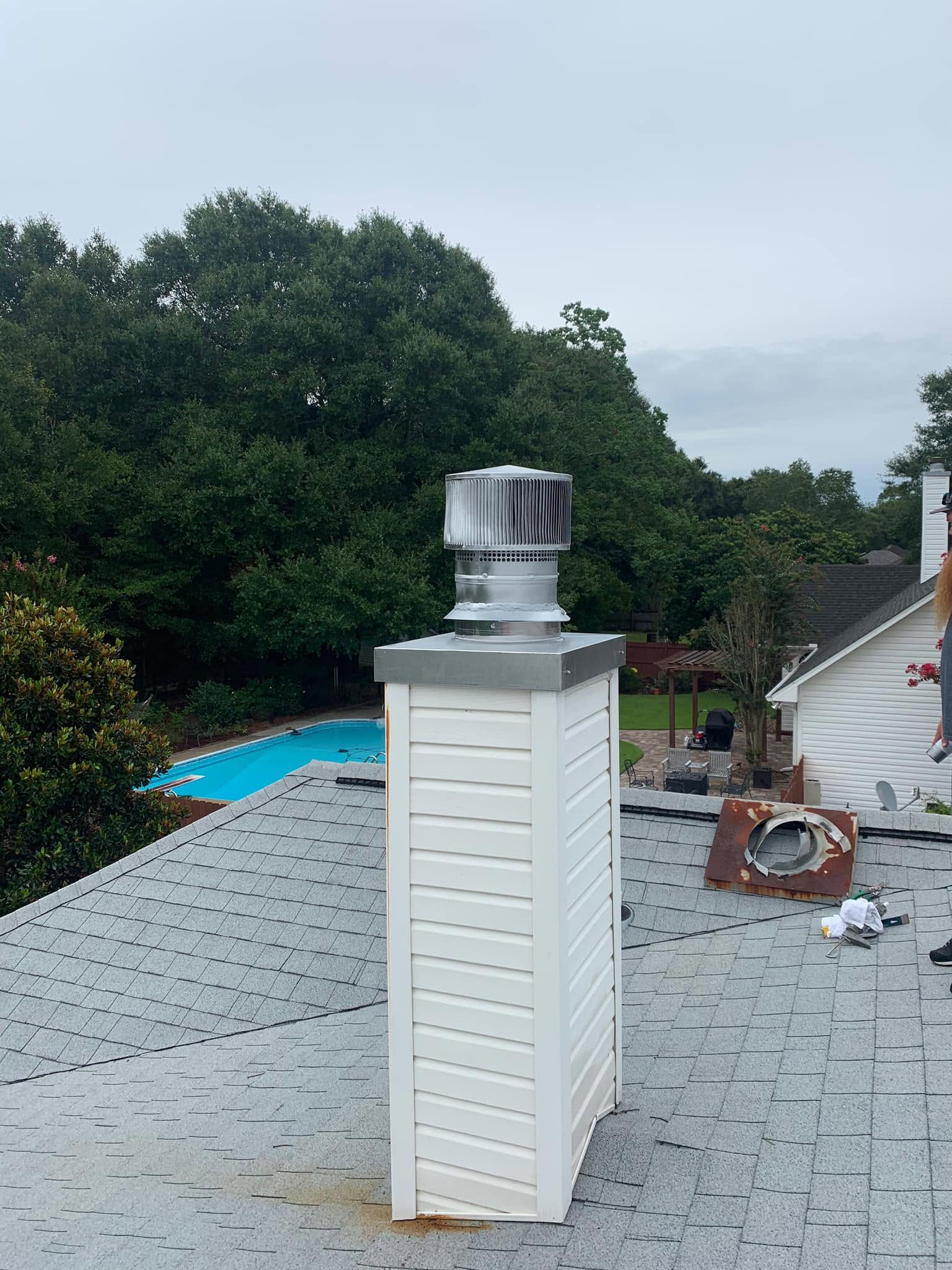 Standard Prefab chimney cap and custom chase cover installed to protect the chimney from water, debris, and weather.