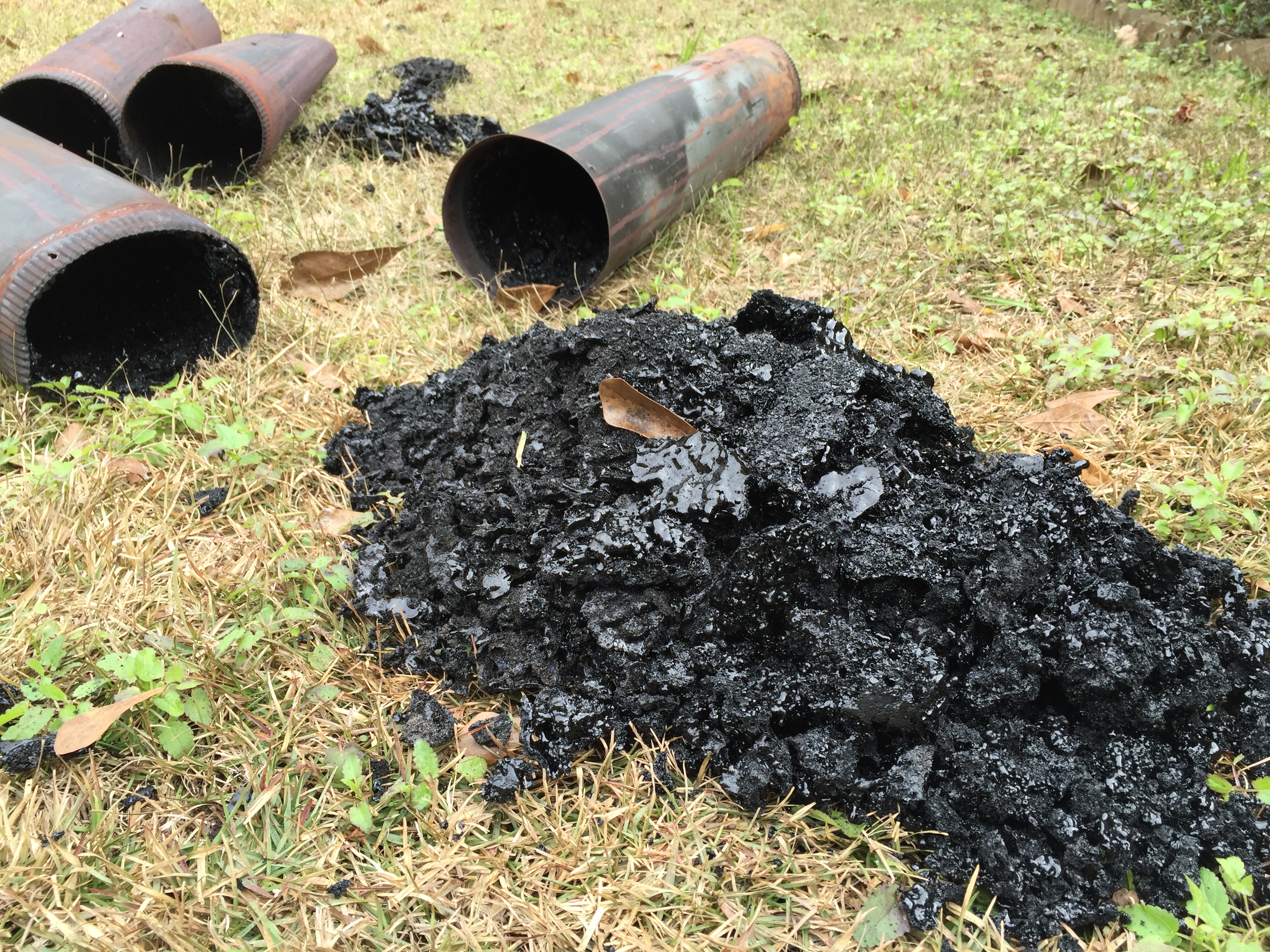 Heavy creosote removed from a residential chimney pipe during a professional chimney sweep.