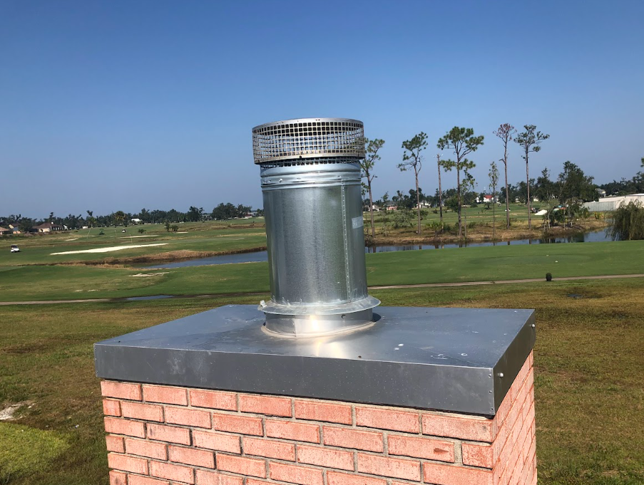 Chimney with a new top section of pipe and chimney cap installed to restore protection and proper function.