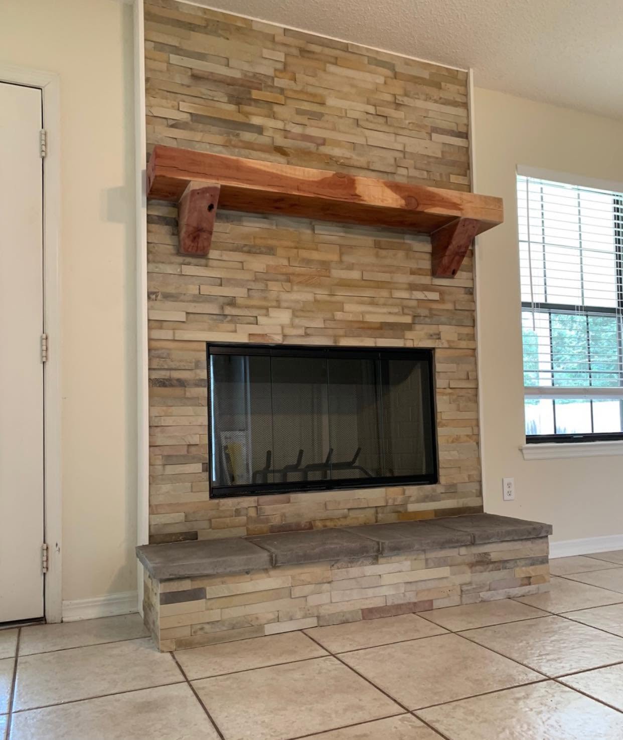 Brand new fireplace installation featuring a custom facade and handcrafted mantle designed for the home.