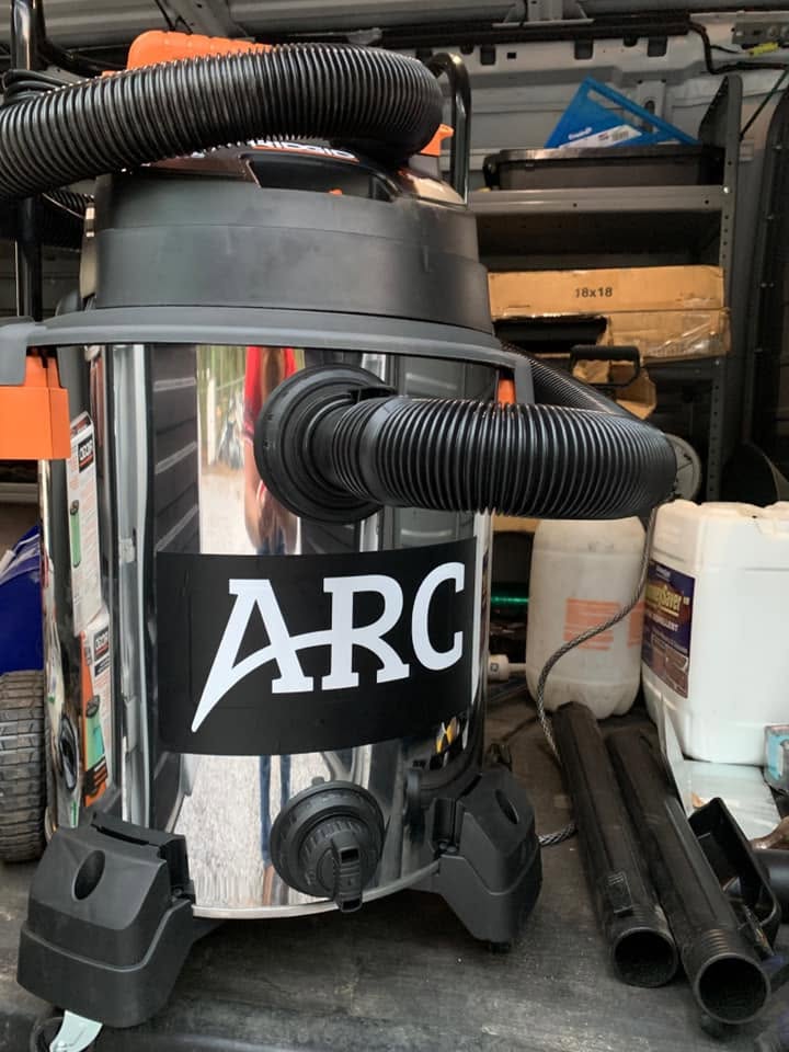 Professional chimney cleaning vacuum featuring the ARC Chimney Sweeps logo used for residential chimney services.