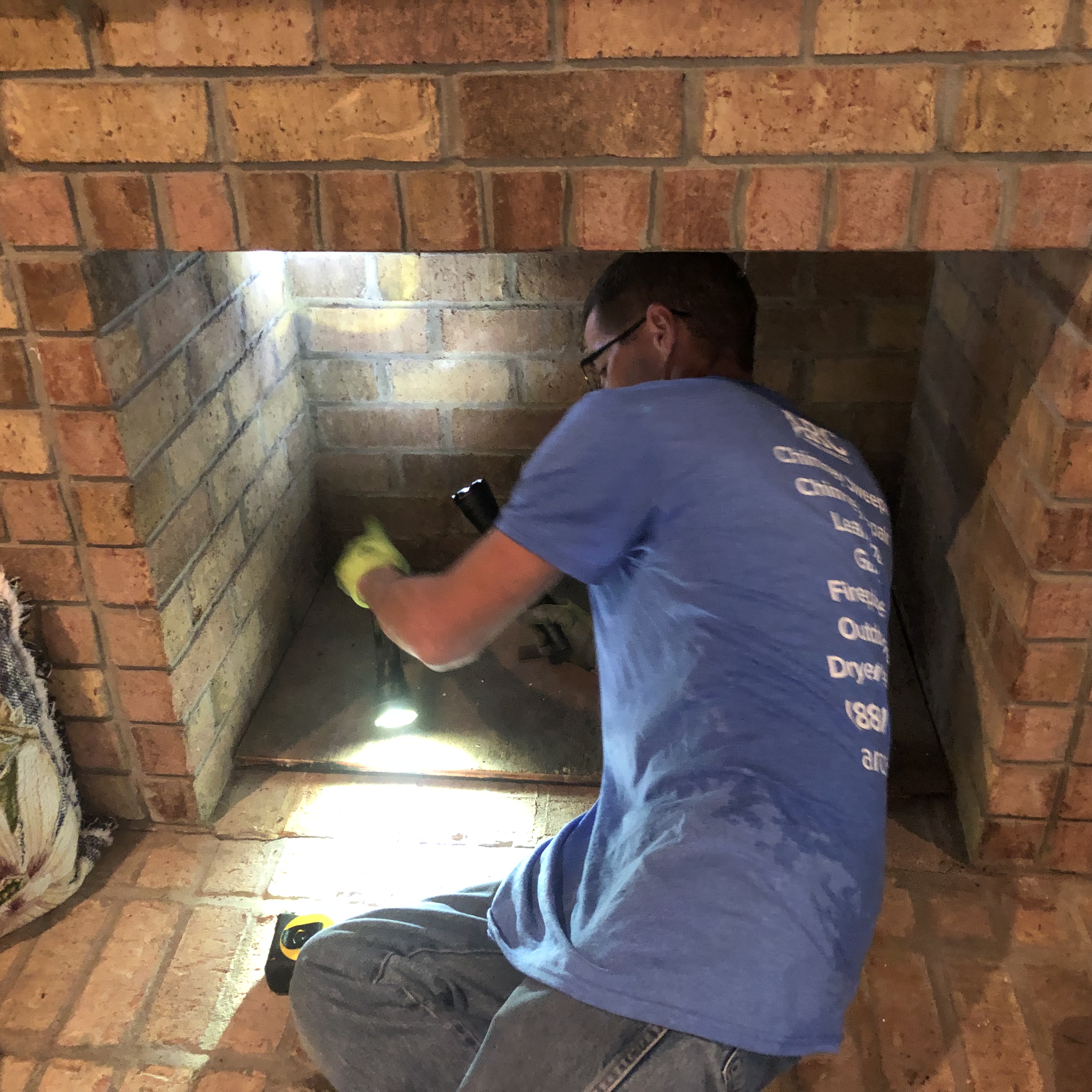Professional chimney technician performing a residential chimney inspection to identify safety issues and needed repairs