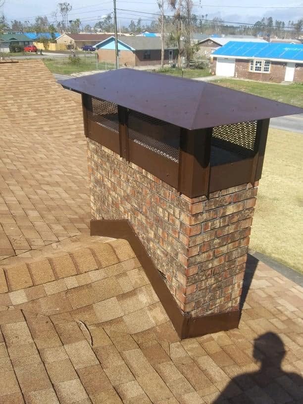 Custom hip and ridge chimney cap with brown powder-coated finish designed to match the home's exterior.