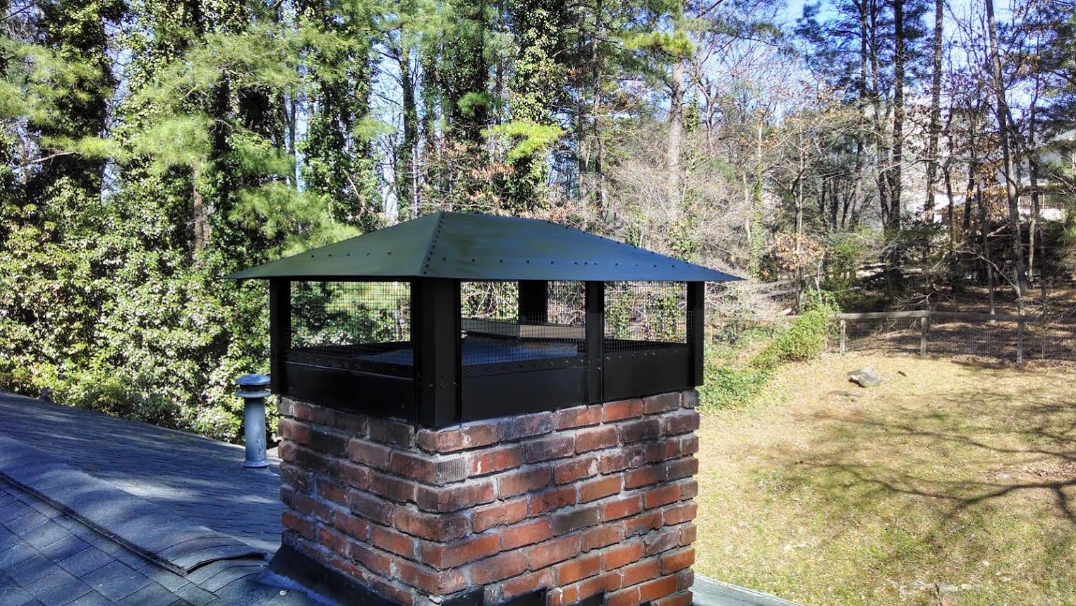 Custom hip and ridge chimney cap fabricated to complement the home's roofline and protect the chimney.