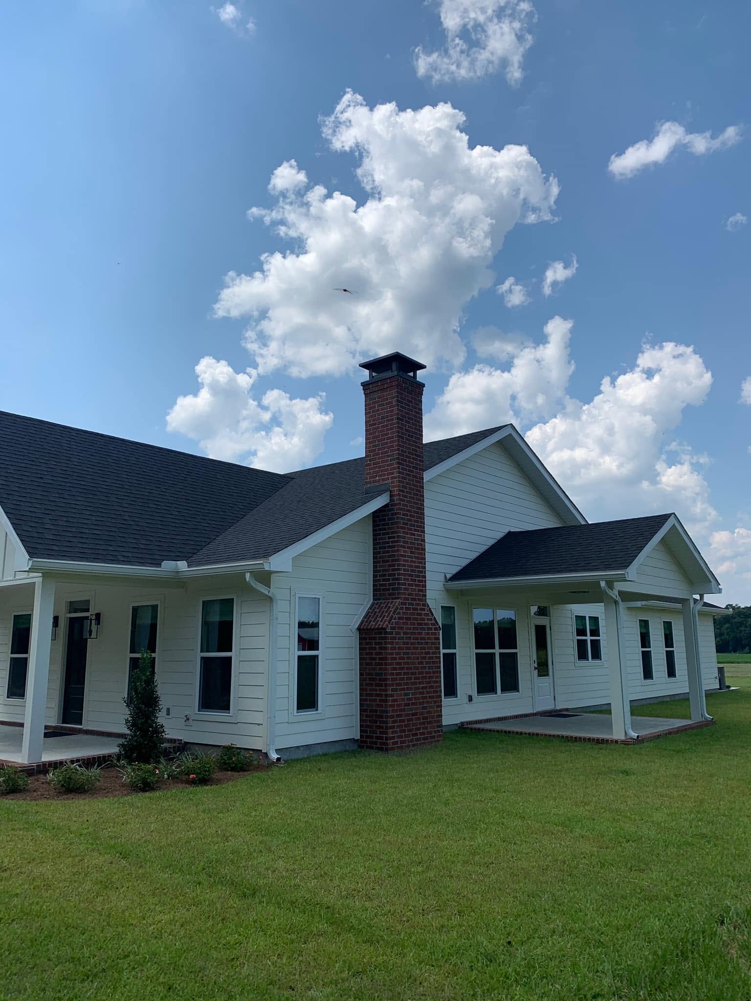 New custom chimney cap professionally installed to protect the chimney from rain, animals, and debris.
