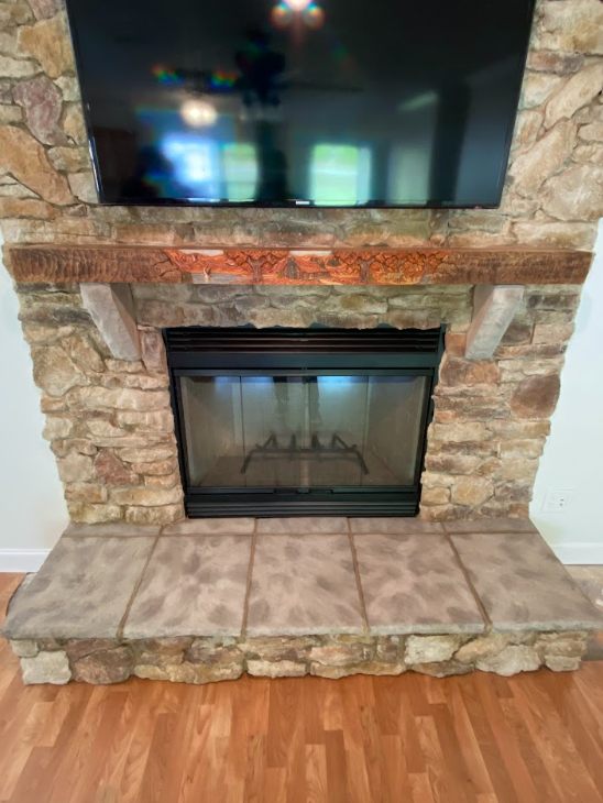 Fireplace with newly installed stone facade creating a custom, updated focal point in the room.
